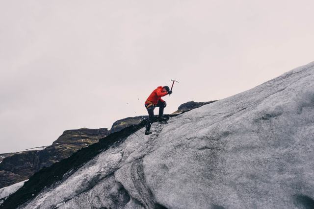 Climber with ice axe on a glacier